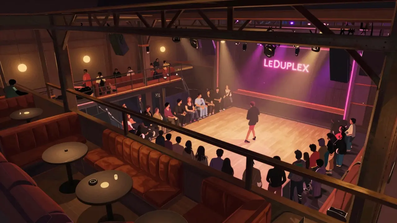 View from mezzanine overlooking vibrant dance floor with plush seating and neon accents.